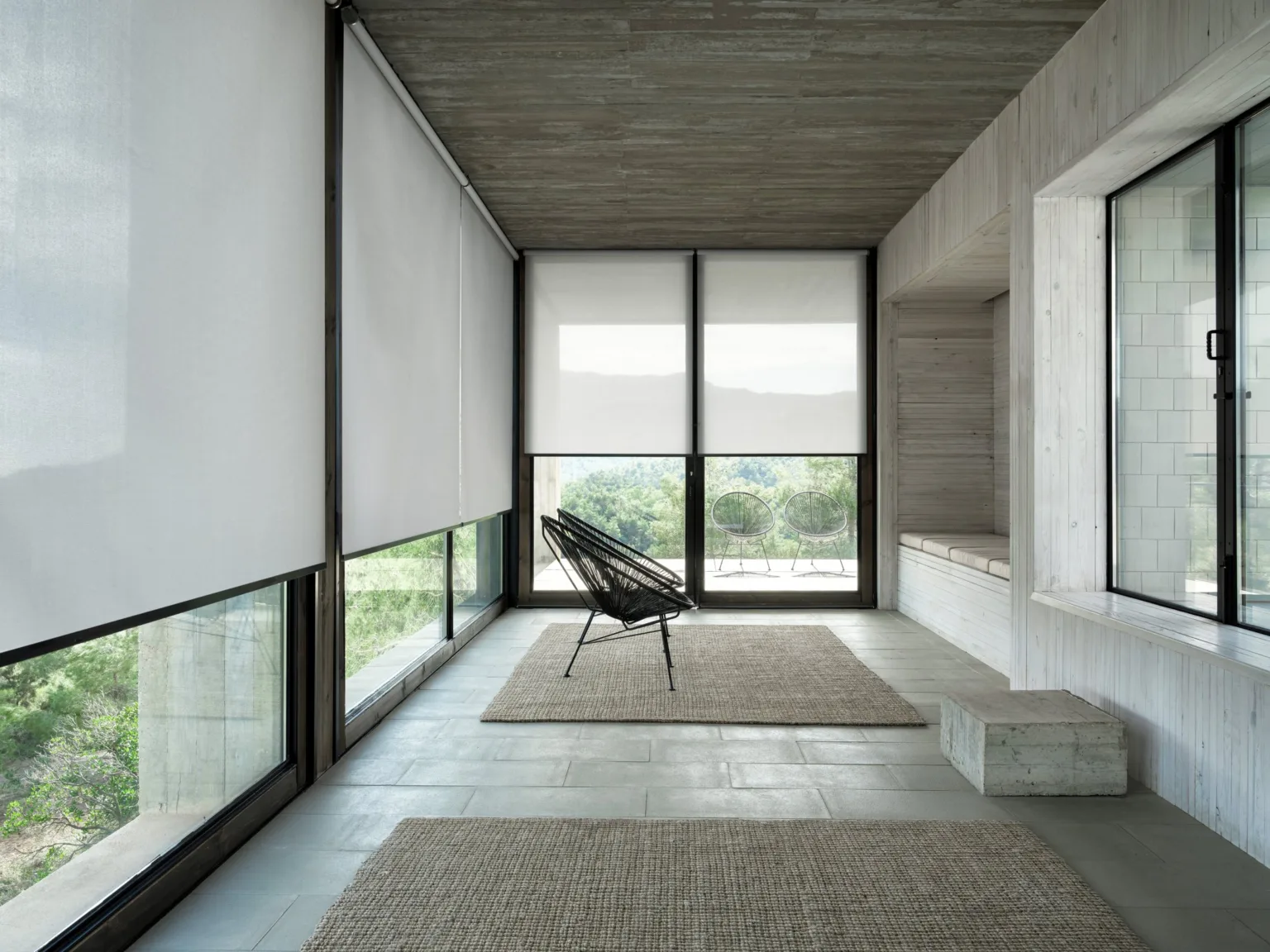 Rulouri screen albe într-un interior minimalist din beton
